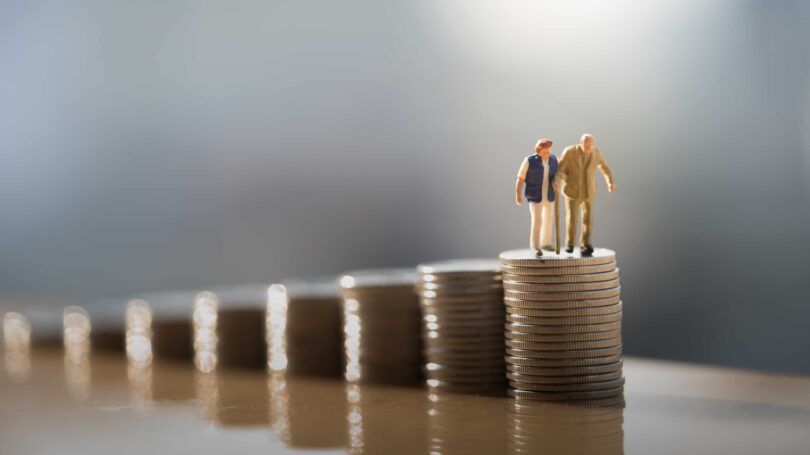 Retirement Planning Old Couple Walking Up Stacks Of Coins