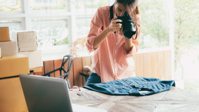 Woman Taking Photo Of Denim Jacket To Sell Online Own Business